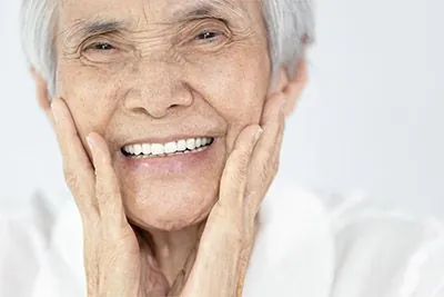 woman loving the look of her smile thanks to dentures from Dynamic Dental in Louisville, KY