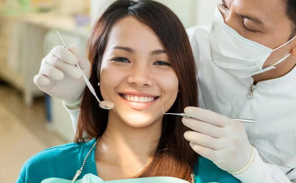 woman getting her teeth cleaned at Dynamic Dental in Louisville, KY